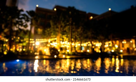 Blurred Image Of Decorative Outdoor Lighting Lamps In Garden By The Pool At Wedding Party. Light Up Decoration For Reception.