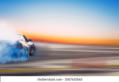 Blurred Of Image Diffusion Race Drift Car With Lots Of Smoke From Burning Tires On Speed Track At Sunset. 