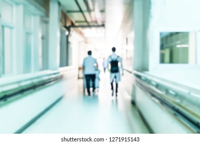 Blurred Image Of Doctor And Nurses Walking On The Path In The Hospital Building.