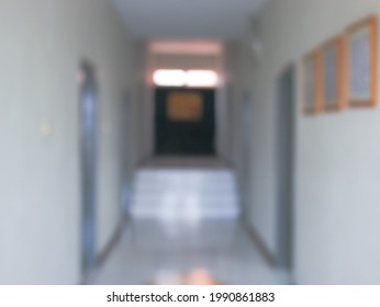 Blurred Image Of A Dormitory Hallway With Doors And A Stairway In The Middle