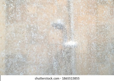 Blurred image of dry water hard stain of soap and shampoo on glass in the bathroom. Difficult to clean. Copy space.