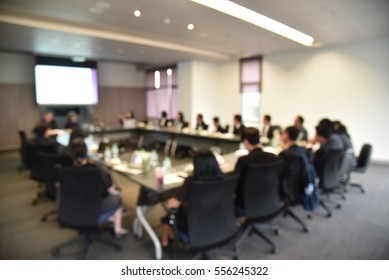Blurred image of education people and business people sitting in conference room for profession seminar and the speaker is presenting new technology and idea sharing with the content activity project.