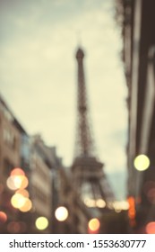 Blurred Image Of Eiffel Tower In Paris At Night With Street Lights.