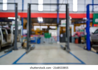 Blurred Image Of Electric Elevator For Car In Repair Shop Installed On An Epoxy Floor In A Car Factory Service. Auto Repair Service Center Blur The Background For The Automobile Industry.