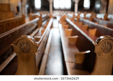 Blurred image of empty pews inside protestant church in Europe. Wide angle view, natural window light, no people
