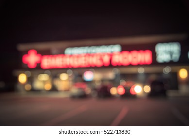 Blurred Image Exterior Emergency Room With Neon Led Sign Illuminated At Night In Houston, Texas, US. Facade Of Emergency Department Neon Shining Signboard. Healthcare Service Concept. Vintage Filter.