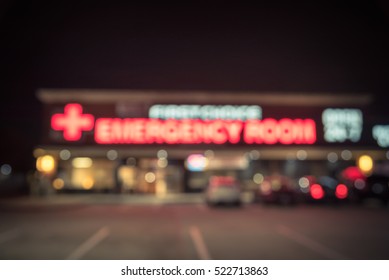 Blurred Image Exterior Emergency Room With Neon Led Sign Illuminated At Night In Houston, Texas, US. Facade Of Emergency Department Neon Shining Signboard. Healthcare Service Concept. Vintage Filter.