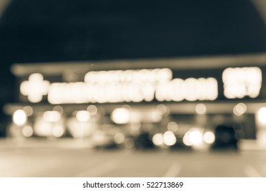 Blurred Image Exterior Emergency Room With Neon Led Sign Illuminated At Night In Houston, Texas, US. Facade Of Emergency Department Neon Shining Signboard. Healthcare Service Concept. Vintage Filter.