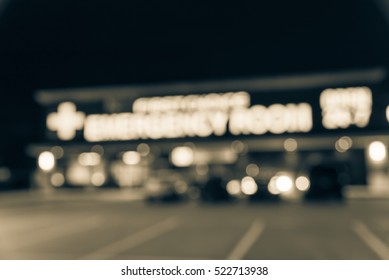 Blurred Image Exterior Emergency Room With Neon Led Sign Illuminated At Night In Houston, Texas, US. Facade Of Emergency Department Neon Shining Signboard. Healthcare Service Concept. Vintage Filter.