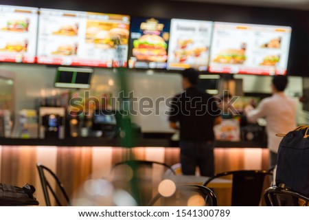 Blurred image of a fast food restaurant, also known as a quick service restaurant within the airport.