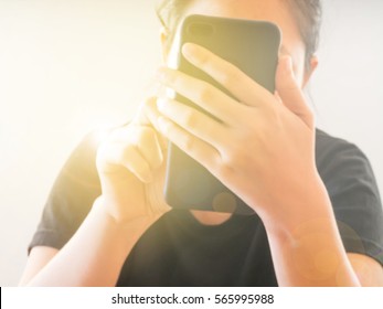 Blurred image of female using smart phone.Concept of communication,technology