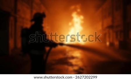 A blurred image of a firefighter using a hose to extinguish a fire in a city street at night