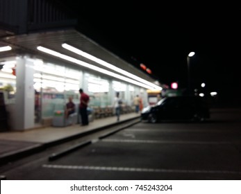 Blurred Image In The Front Of The Convenience Store At Night.