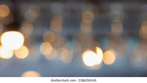 Blurred image of glass hanging at a bar drinking a drink. Bright lights in a restaurant. Abstract background. - Shutterstock ID 2186354145