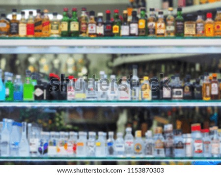 Blurred image. Glass showcase with alcohol products, blurred alcoholic beverage background. Alcohol drink market concept.