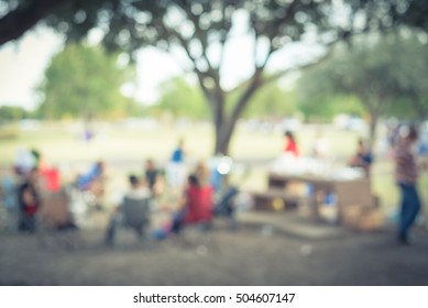 Blurred Image Group Of Local Latino People Enjoy BBQ At Bear Creek Park In Houston, Texas, US. BBQ Grill In Park With Family And Friends. Meat Skewers Smoke. Party And Picnic Concept. Vintage Filter.