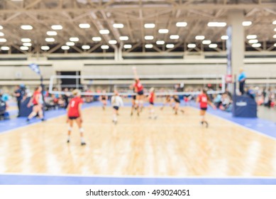 Blurred Image Group Of Teen Girls Playing Indoor Volleyball. Volleyball Competition Blur Background. High School Volleyball Tournament Concept.