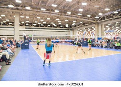 Blurred Image Group Of Teen Girls Playing Indoor Volleyball. Volleyball Competition Blur Background. High School Volleyball Tournament Concept.