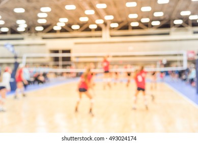 Blurred Image Group Of Teen Girls Playing Indoor Volleyball. Volleyball Competition Blur Background. High School Volleyball Tournament Concept.