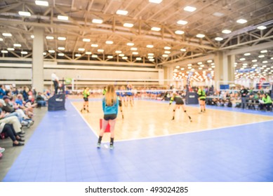 Blurred Image Group Of Teen Girls Playing Indoor Volleyball. Volleyball Competition Blur Background. High School Volleyball Tournament Concept.