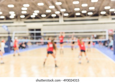 Blurred Image Group Of Teen Girls Playing Indoor Volleyball. Volleyball Competition Blur Background. High School Volleyball Tournament Concept.