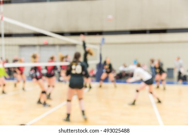 Blurred Image Group Of Teen Girls Playing Indoor Volleyball. Volleyball Competition Blur Background. High School Volleyball Tournament Concept.