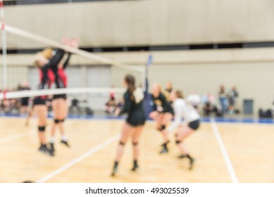 Blurred Image Group Of Teen Girls Playing Indoor Volleyball. Volleyball Competition Blur Background. High School Volleyball Tournament Concept.