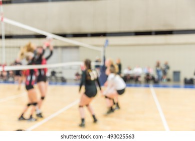 Blurred Image Group Of Teen Girls Playing Indoor Volleyball. Volleyball Competition Blur Background. High School Volleyball Tournament Concept.