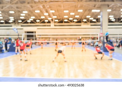 Blurred Image Group Of Teen Girls Playing Indoor Volleyball. Volleyball Competition Blur Background. High School Volleyball Tournament Concept.