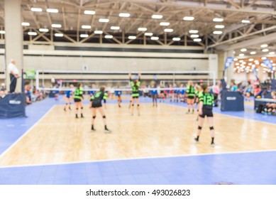 Blurred Image Group Of Teen Girls Playing Indoor Volleyball. Volleyball Competition Blur Background. High School Volleyball Tournament Concept.