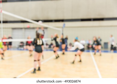 Blurred Image Group Of Teen Girls Playing Indoor Volleyball. Volleyball Competition Blur Background. High School Volleyball Tournament Concept.