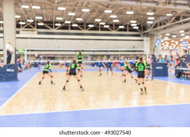 Blurred Image Group Of Teen Girls Playing Indoor Volleyball. Volleyball Competition Blur Background. High School Volleyball Tournament Concept.