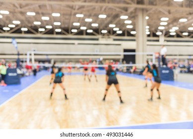 Blurred Image Group Of Teen Girls Playing Indoor Volleyball. Volleyball Competition Blur Background. High School Volleyball Tournament Concept.