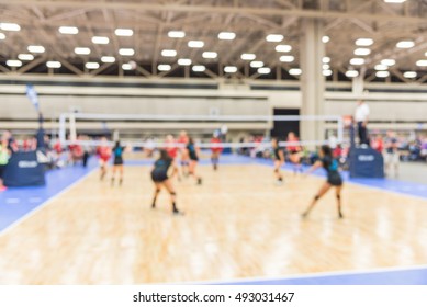 Blurred Image Group Of Teen Girls Playing Indoor Volleyball. Volleyball Competition Blur Background. High School Volleyball Tournament Concept.