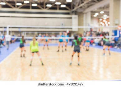 Blurred Image Group Of Teen Girls Playing Indoor Volleyball. Volleyball Competition Blur Background. High School Volleyball Tournament Concept.