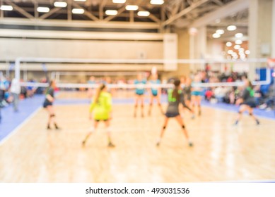 Blurred Image Group Of Teen Girls Playing Indoor Volleyball. Volleyball Competition Blur Background. High School Volleyball Tournament Concept.