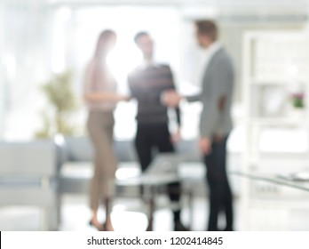 blurred image the handshake of the staff