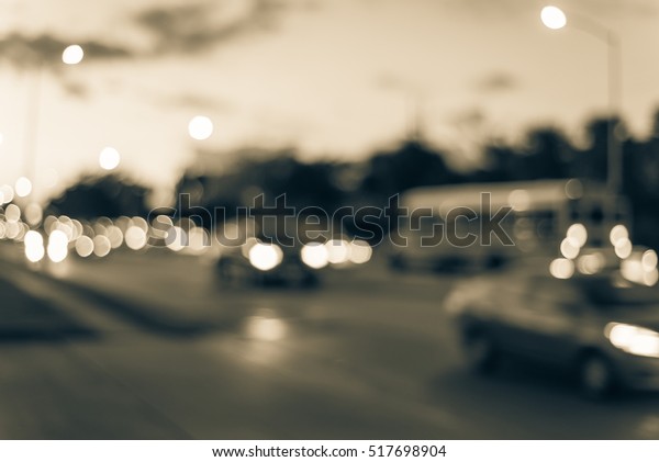 Blurred image of heavy traffic with defocused\
bokeh lights at rush hour at twilight. Out focus traffic jam,\
street lights in Houston, Texas, US. Urban traffic issue abstract\
background. Vintage\
filter