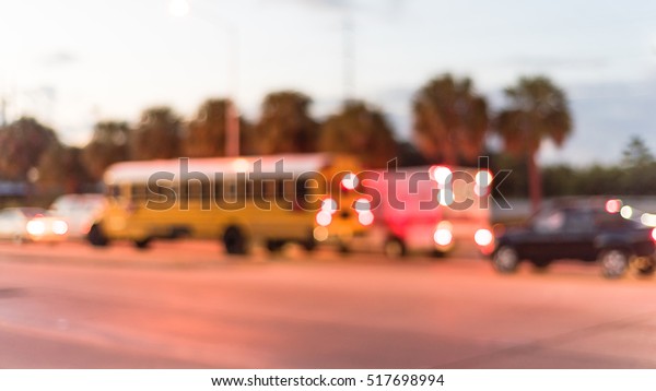 Blurred image of heavy traffic with defocused\
bokeh lights at rush hour at twilight. Out focus traffic jam,\
street lights in Houston, Texas, US. Urban traffic issue abstract\
background. Panorama.