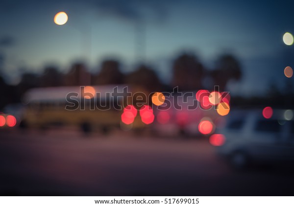 Blurred image of heavy traffic with defocused\
bokeh lights at rush hour at twilight. Out focus traffic jam,\
street lights in Houston, Texas, US. Urban traffic issue abstract\
background. Vintage\
filter