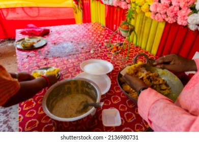 Blurred image of Howrah, West Bengal, India. Vog, prasad, or sacred worshipped food, being distributed to devotees, after worshipping idol of God Jagannath, Balaram and Suvodra inside pandal.