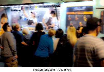 Blurred Image Of Hungry People Gathered At A Late Night Food Truck