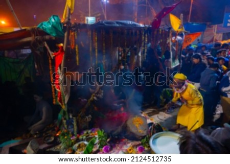 Blurred image of Kolkata, West Bengal, India. Gathering of Indian Hindu Sadhus at their tents, Gangasagar transit camp. Shot at colored light in winter night.