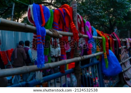 Blurred image of Kolkata, West Bengal, India. Colourful warm winter clothes are being sold at Gangasagar transit camp, Babughat, Kolkata
