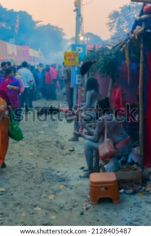 Blurred image of Kolkata, West Bengal, India. Devotees walking at Gangasagar transit camp to visit Hindu sadhus at their camps , at Babughat, Kolkata.