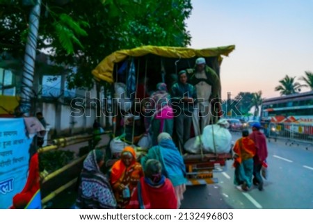 Blurred image of Kolkata, West Bengal, India. Hindu devotees getting up to a truck to reach Gangasagar, shot at Babughat, Gangasagar transit camp at Kolkata.
