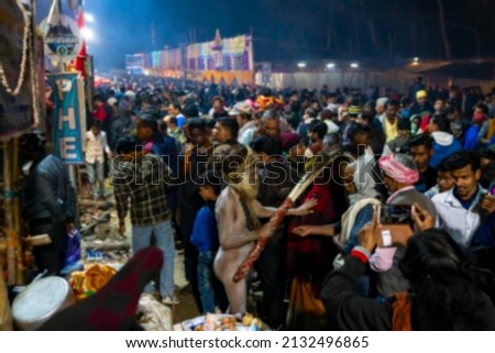 Blurred image of Kolkata, West Bengal, India. Hindu Sadhu blessing devotees at Gangasagar transit camp, Outtram ghat. Huge number of devotees gather in the camp to have the holy blessing.