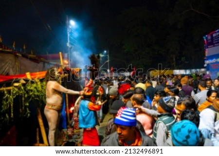 Blurred image of Kolkata, West Bengal, India. Hindu Sadhu blessing devotees at Gangasagar transit camp, Outtram ghat. Huge number of devotees gather in the camp to have the holy blessing.