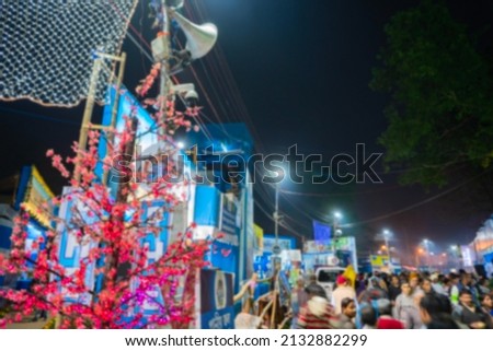 Blurred image of Kolkata, West Bengal, India. Hindu Devotees walking in the evening at Gangasagar transit camp to visit and get blessings of Hindu sadhus at their camps , at Babughat, Kolkata.