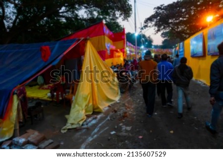 Blurred image of Kolkata, West Bengal, India. Devotees walking at Gangasagar transit camp to visit Hindu sadhus at their camps , at Babughat, Kolkata.